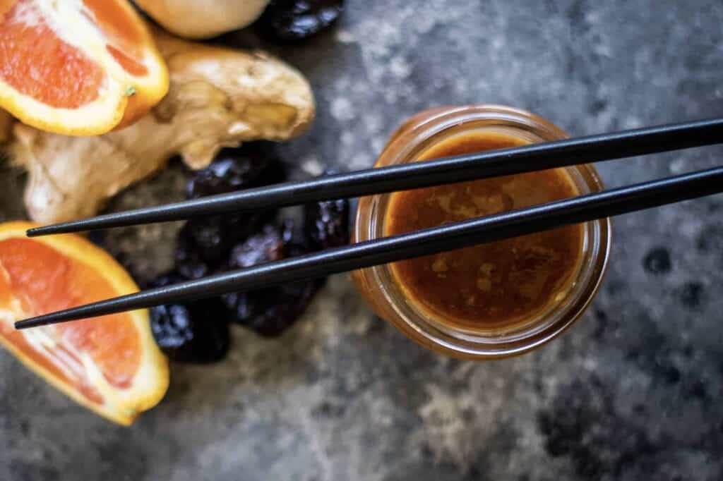 a jar of Homemade Teriyaki Sauce with two chopsticks on top