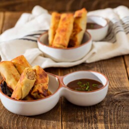 a bowl of Lumpia with Prune Puree Chili Sauce
