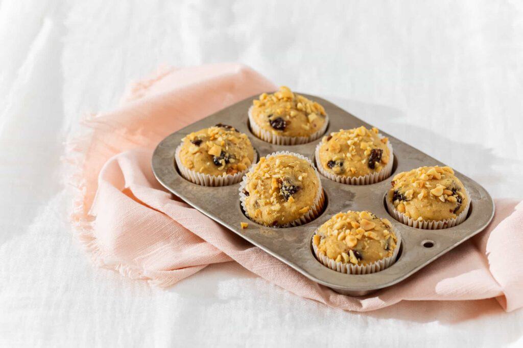 A cupcake tray full of Peanut Butter Banana Muffins