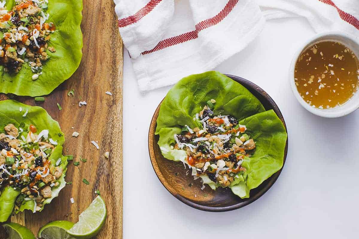 a plate with a Turkey Lettuce Wrap next to a bowl of dipping sauce