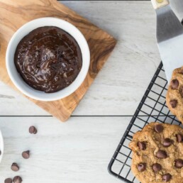 bowl of Prune Puree, bowl of chocolate chips and a cooling rack with Chocolate Chip Cookies
