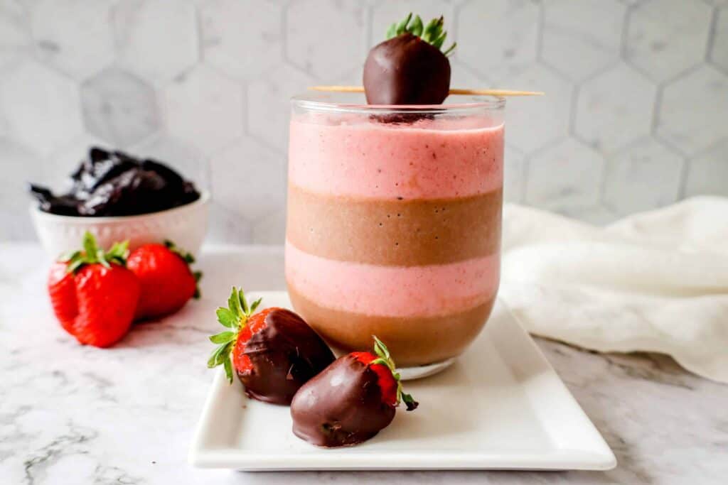 Chocolate Strawberry Smoothie on a white plate with chocolate covered strawberry garnish