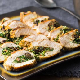 a baking tray filled with Prune and Ricotta Stuffed Chicken Breasts