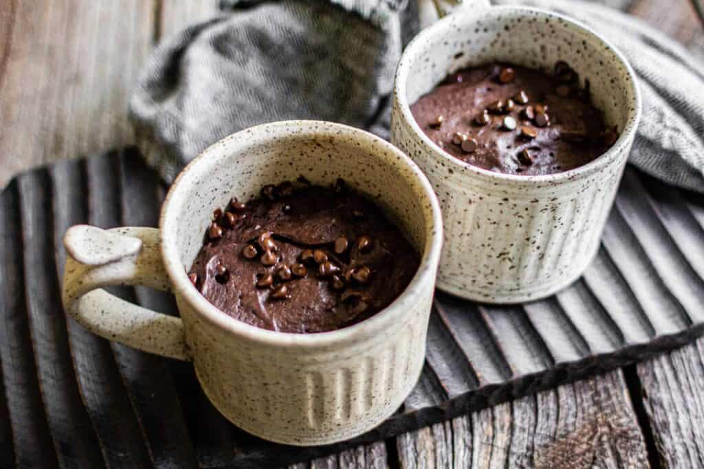 two white mugs filled with Chocolate Mug Cake