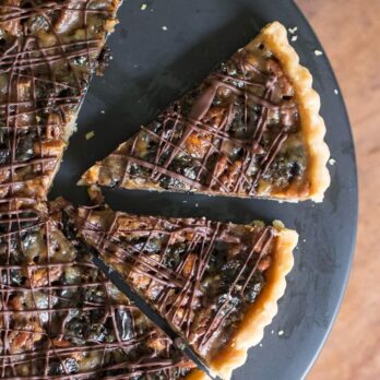 Caramelized Pecan & Prune Tart with two slices cut out