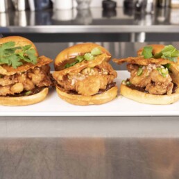 a white plate with three Fried Chicken Sandwiches