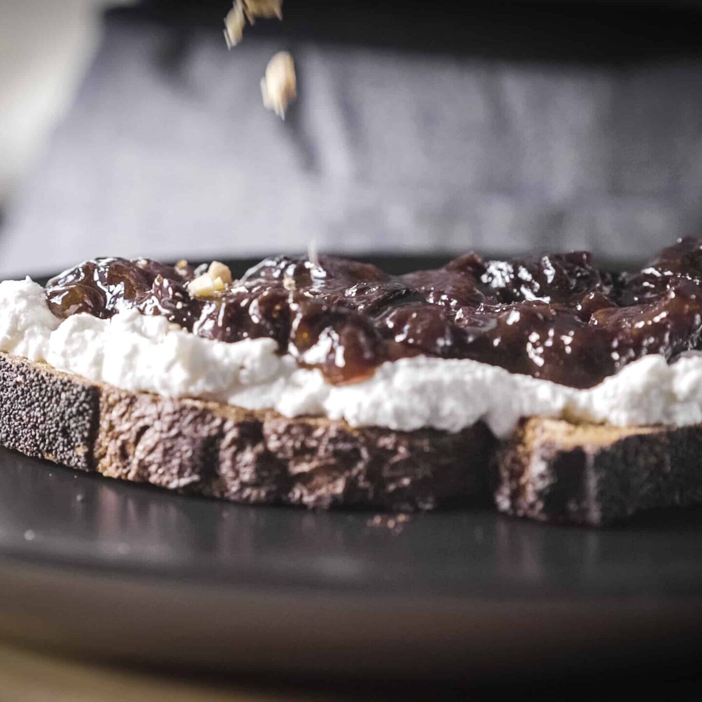 Five Spice California Prune Jam on top a a piece of toast with ricotta