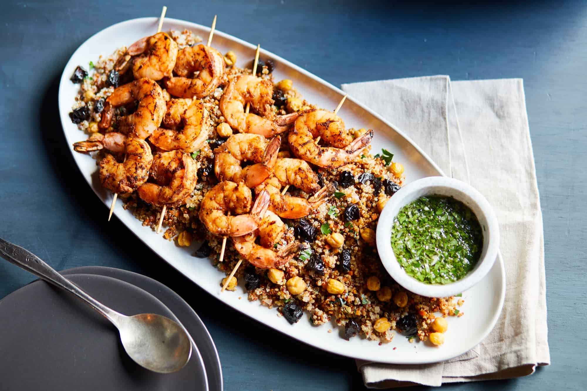 a plate of Moroccan Spiced Shrimp Skewers on top of a bed of rice