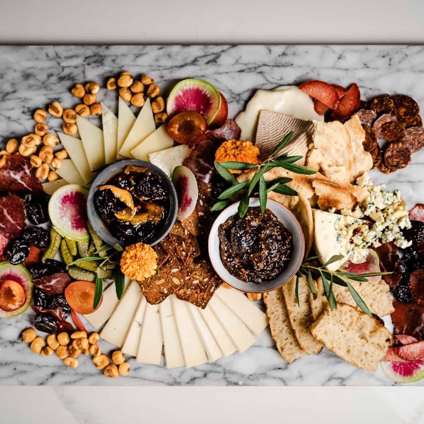 The Ultimate Cheese Board with Pink Peppercorn Prune Syrup, Prune Mostarda, cheeses fruit and corn nuts