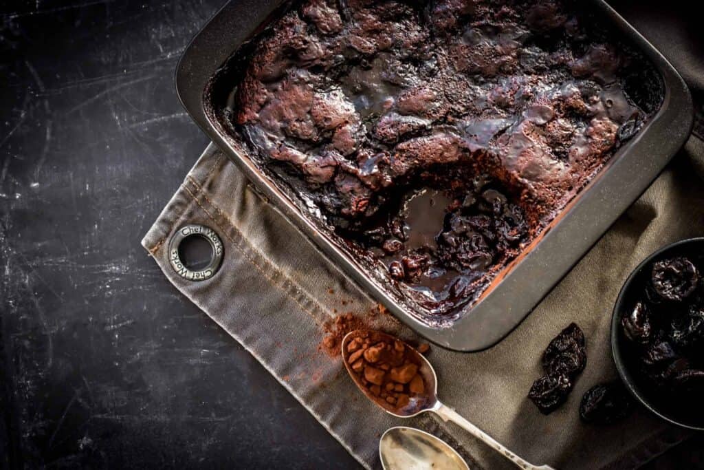 a baking dish with Chocolate Pudding Cake with a slice removed
