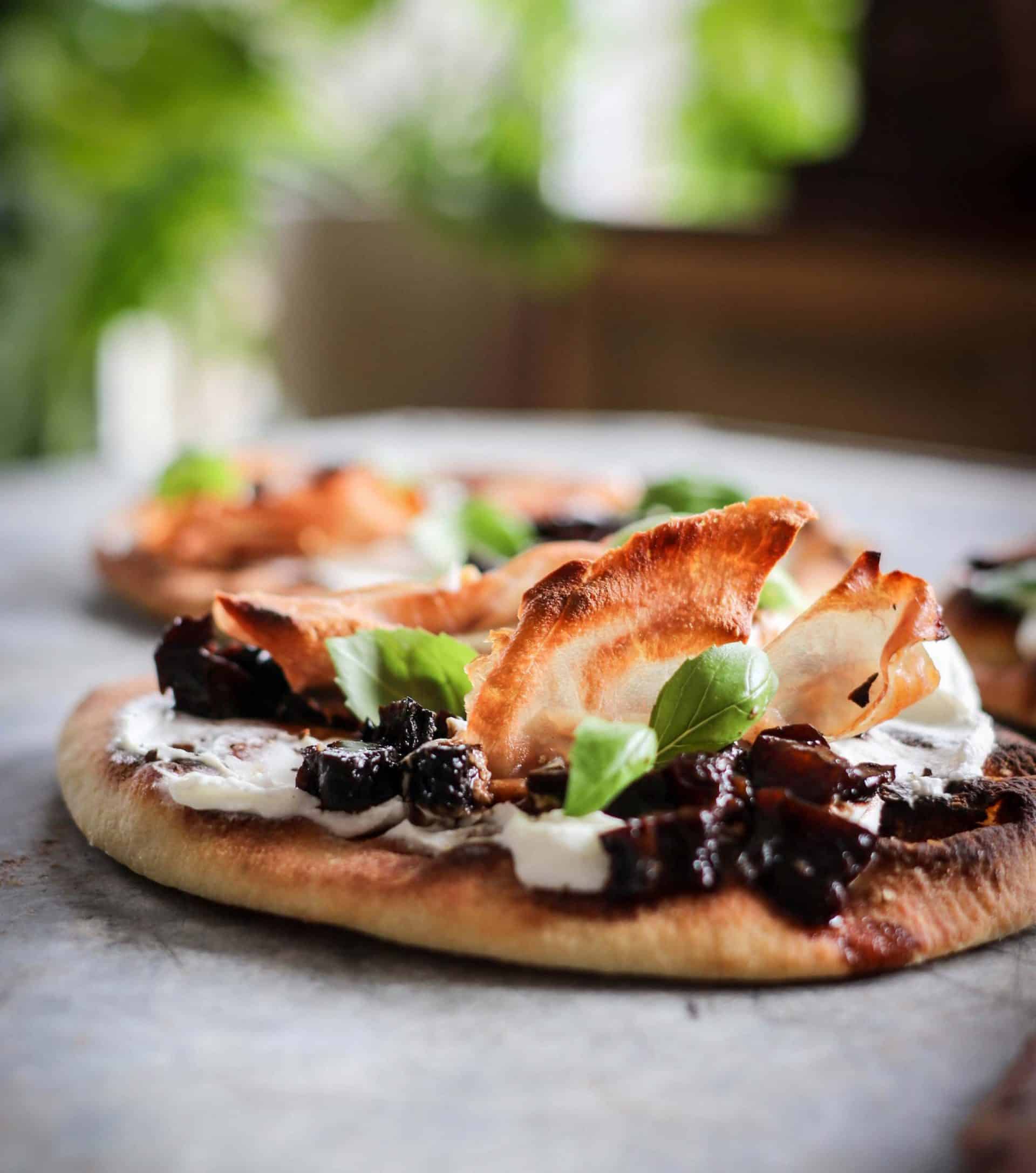 a flatbread topped with Goat Cheese and Prosciutto Flatbreads