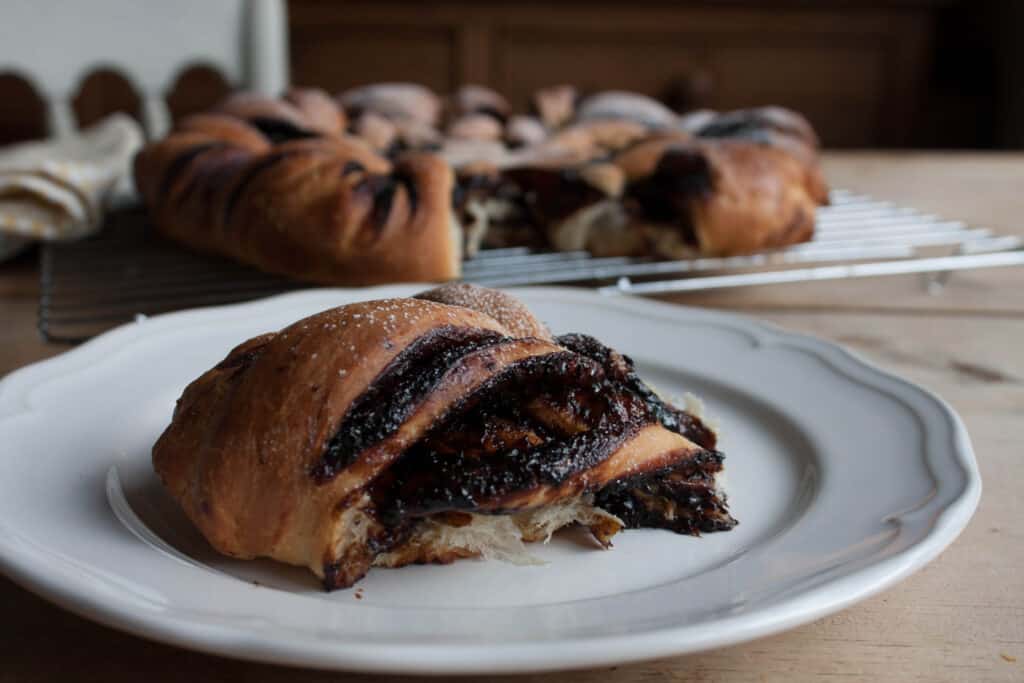 a piece of Tear and Share California Prune Brioche on a white plate