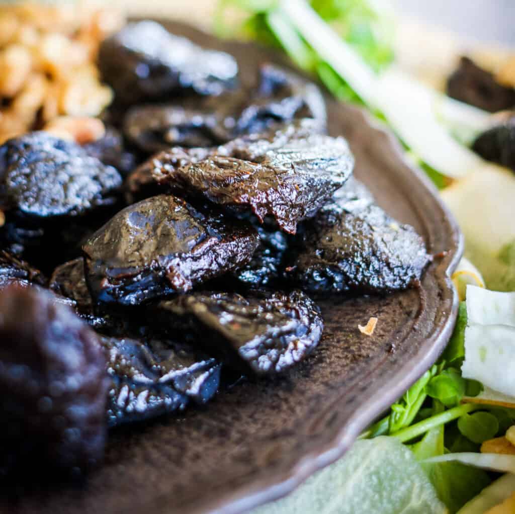 Prunes on a plate with Pear Prune Fennel Salad