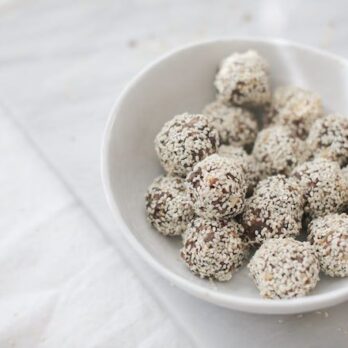 a white bowl full of Sesame Seed Energy Balls from Nutrition Stripped