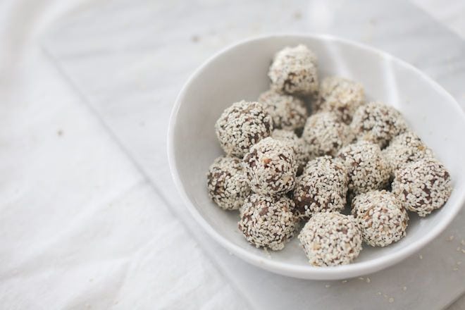 a white bowl full of Sesame Seed Energy Balls from Nutrition Stripped