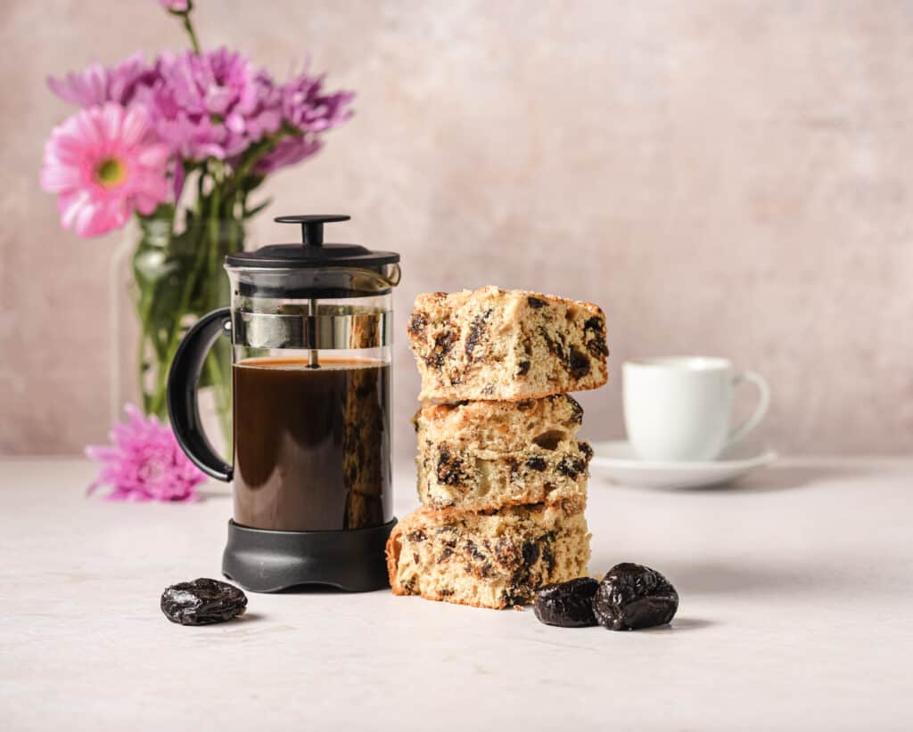 Three slices of Coffee Cake from Georgeanne Brennan with a French press full of coffee