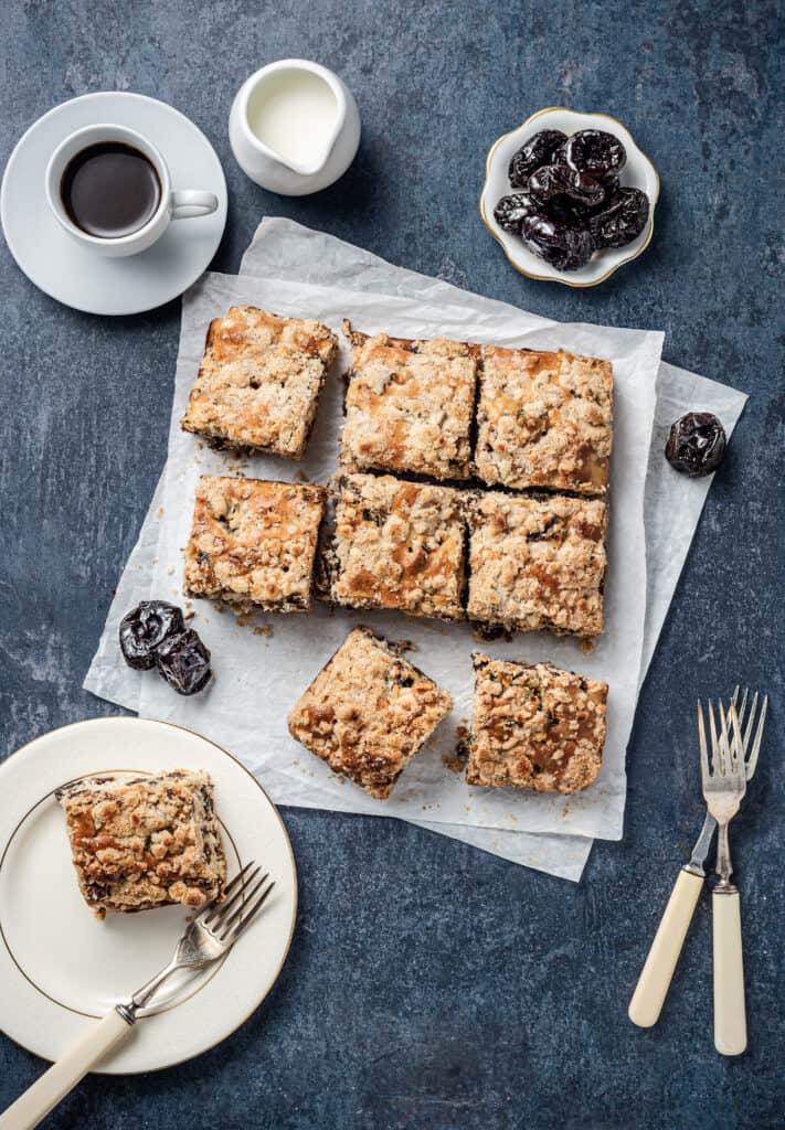Sliced Almond Crumble Coffee Cake from Georgeanne Brennan with a cup of coffee and prunes