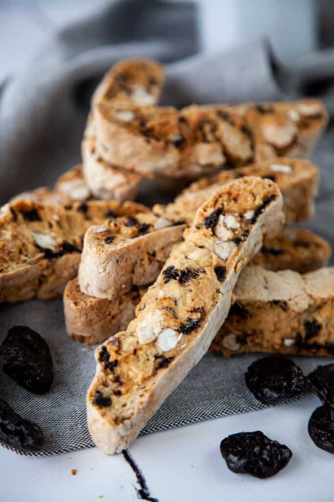 pieces of prune and hazelnut biscotti on a napkin with prunes