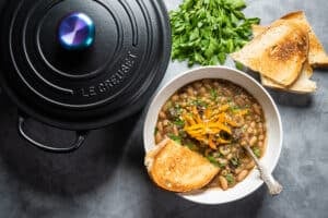 a black pot with a bowl of Beans Marbella