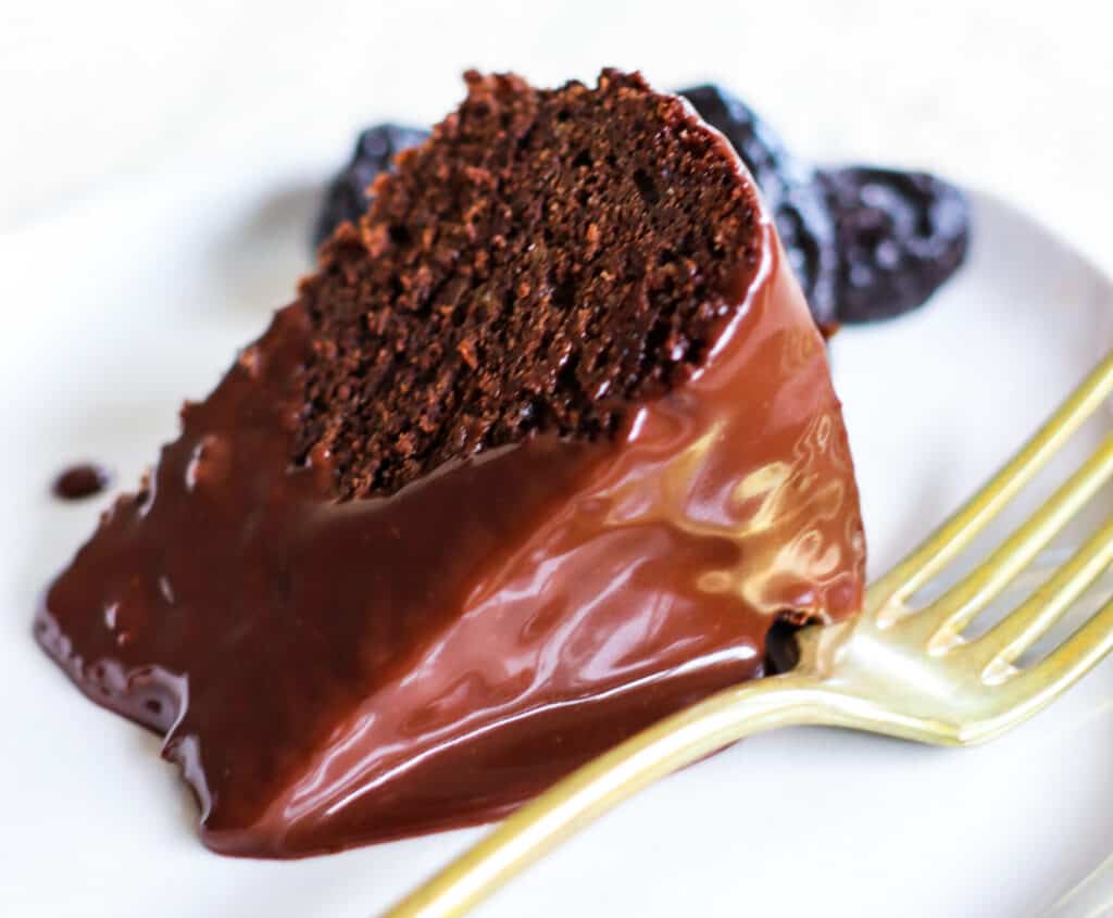 A slice of Gluten-free, grain-free chocolate cake with a fudge drizzle
