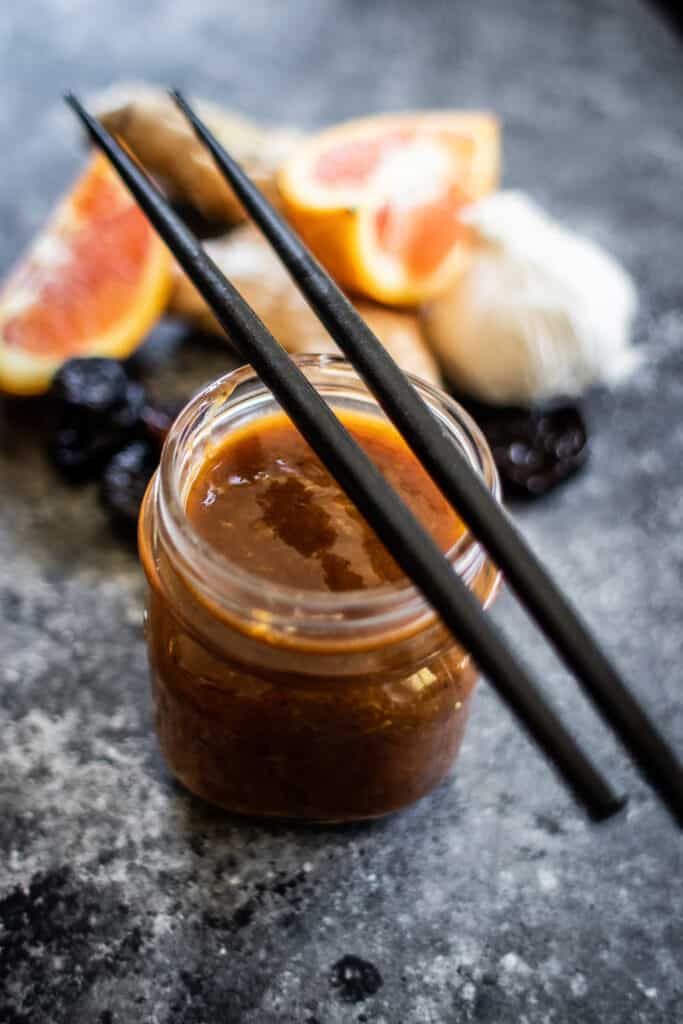 jar of teriyaki sauce with chopsticks resting on top