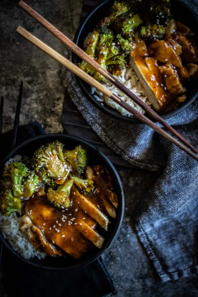 sheet pan chicken teriyaki bowls with chopsticks on top