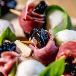 a close up of Prune Basil and Mozzarella Skewers