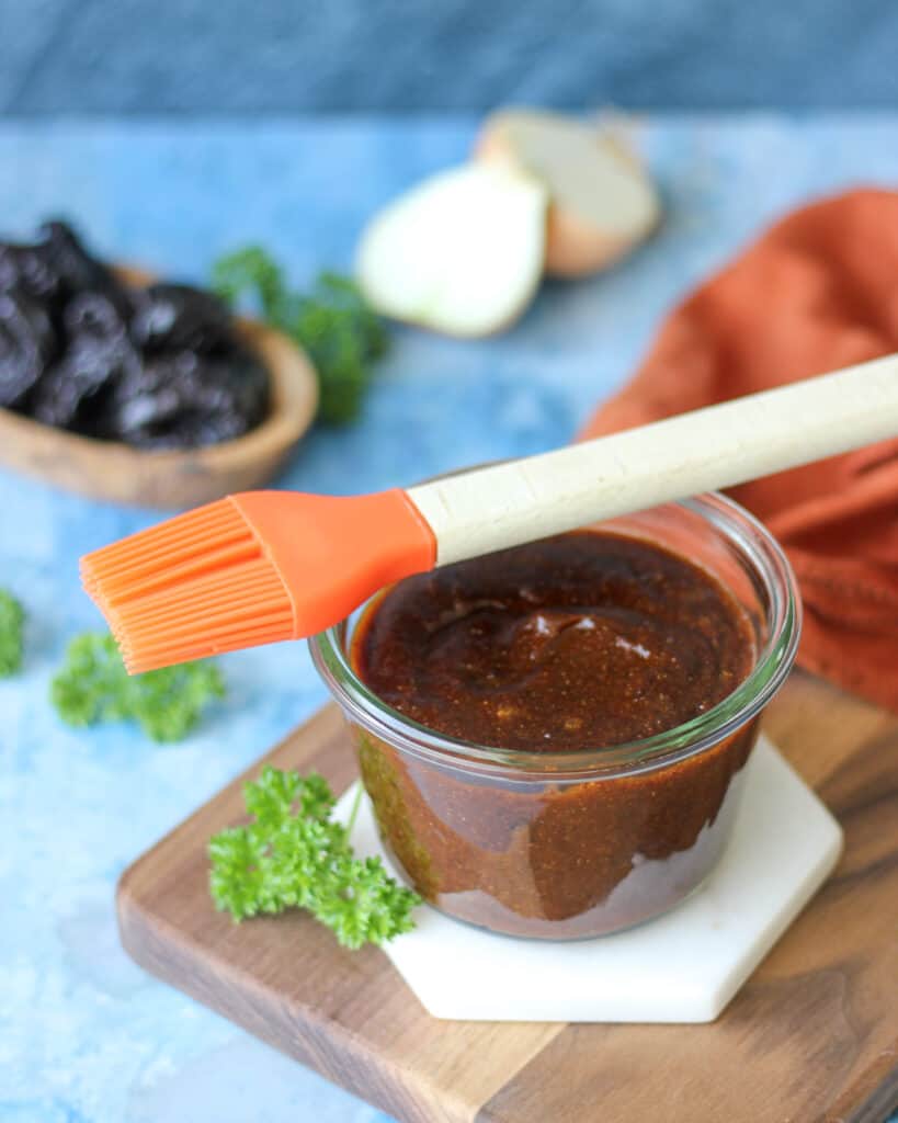 a jar of California Prune BBQ Sauce with a basting brush on top