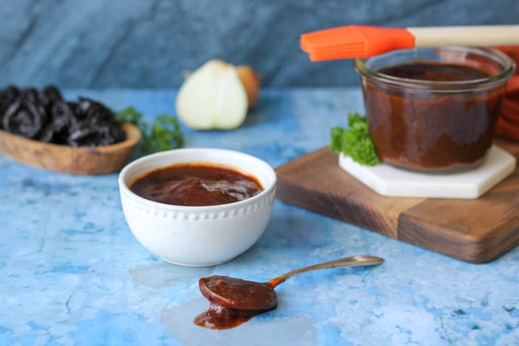 a spoon coated with Homemade California Prune BBQ Sauce 