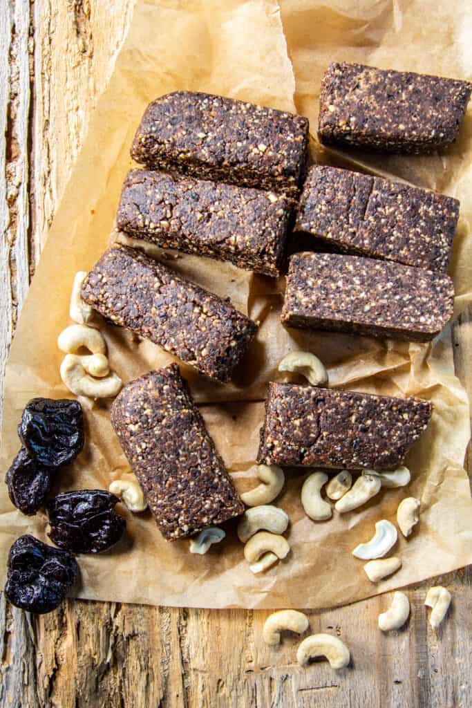 Chocolate Fudge Raw Bar slices on parchment paper with cashews and prunes
