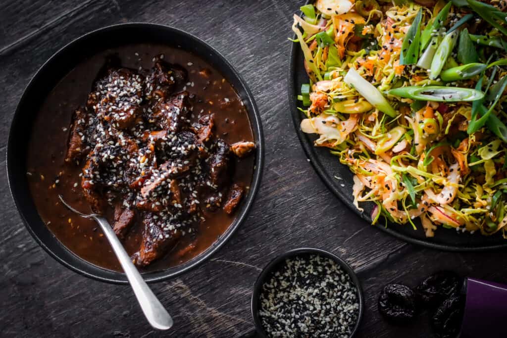 a bowl of Korean-style BBQ Beef and another bowl of Kimchi Slaw by Peter Sidwell