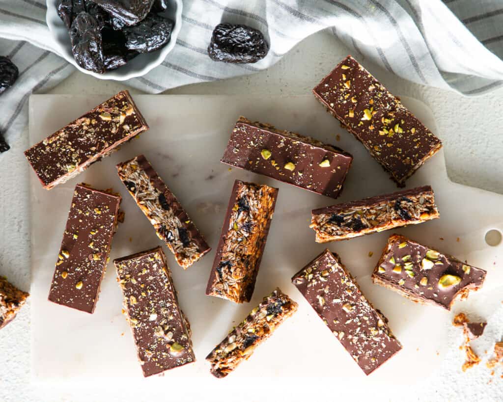 slices of Prune, Chocolate and Oat Bars from Bake from Scratch and a bowl of prunes