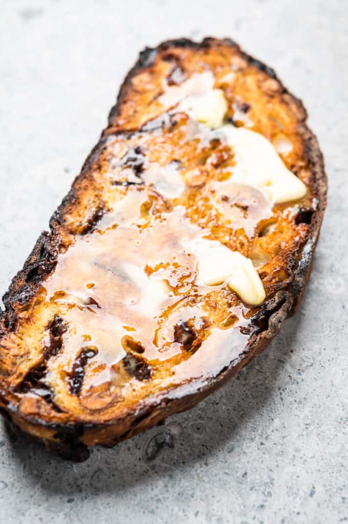 Slice of buttered Prune bread with cardamom and pecans