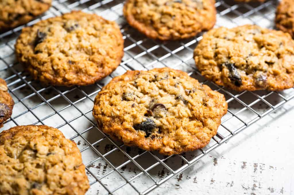 Cooling rack with Chewy Oatmeal Cookies with Chocolate and Chopped Prunes. This riff on our Chewy Oatmeal Chocolate Chip Cookies is inspired by one of our growers, who swaps the puree for chopped prunes, and uses dark honey from his own hives to give these an even richer flavor.