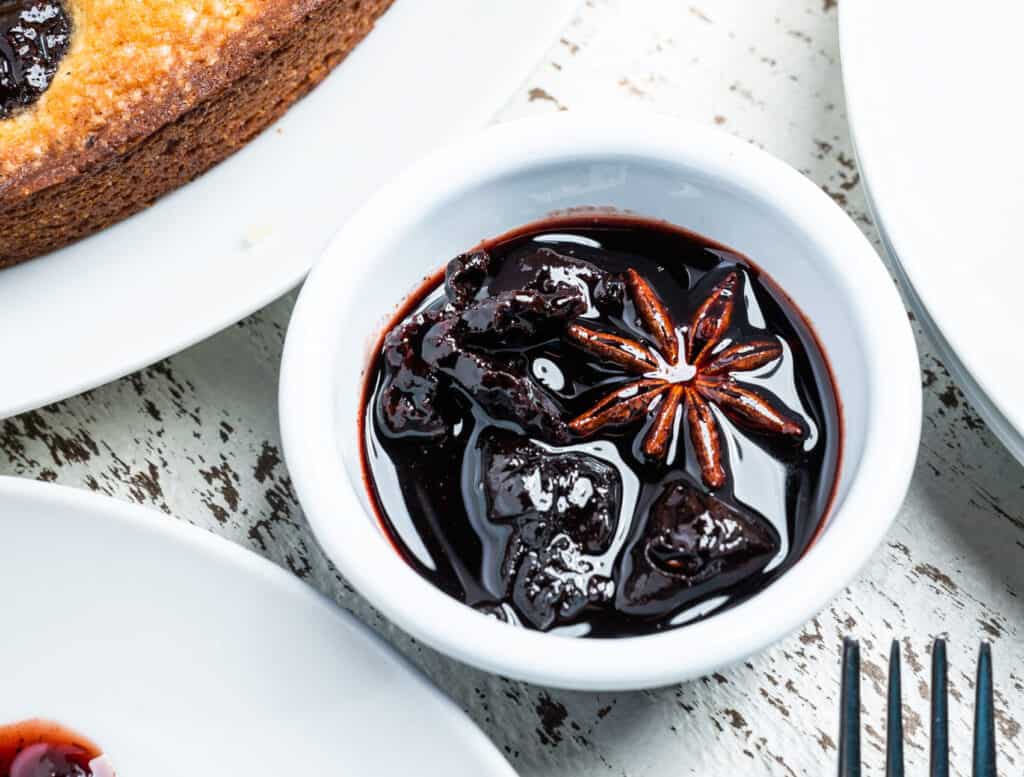 Prunes soaked in a red wine and spice sauce for Mascarpone Cake