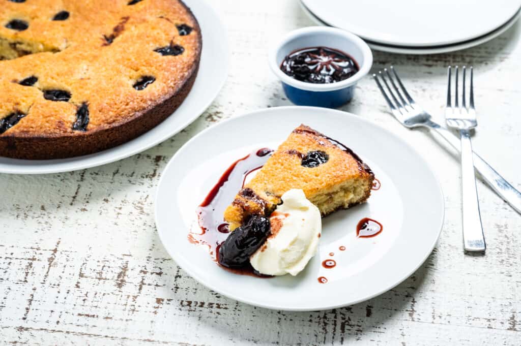 a slice of Red Wine Mascarpone Cake with whipped cream