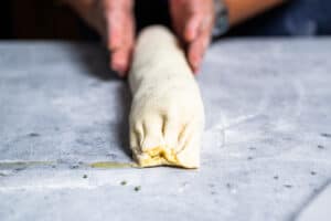 rolling a goat cheese strudel