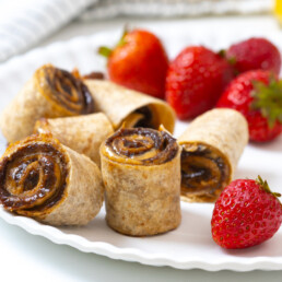 Prune Peanut Butter Pinwheels with strawberries on plate
