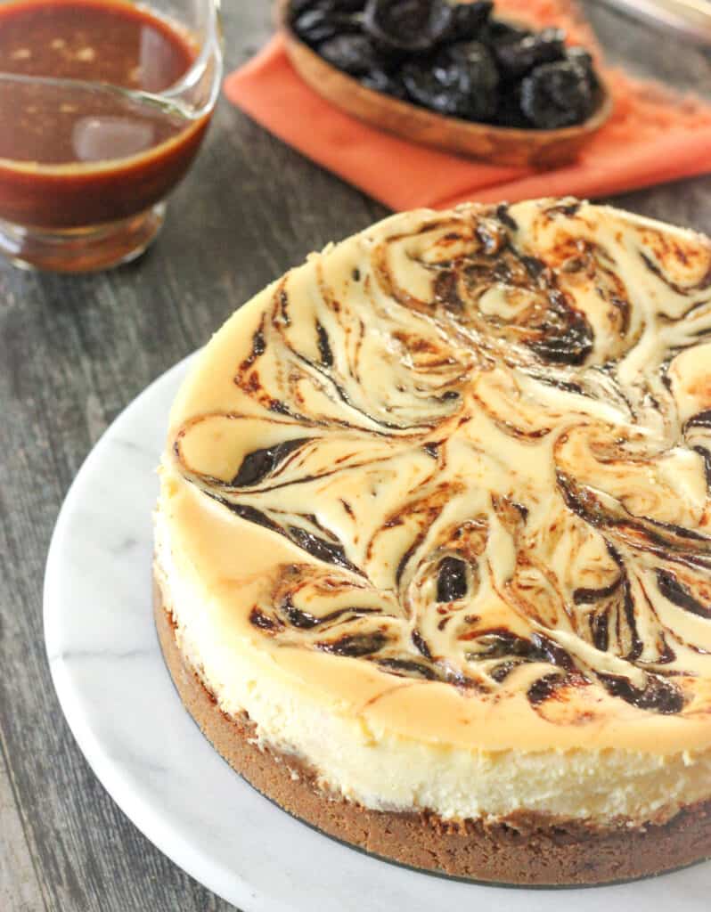 a plate of Rum-Soaked Prune Cheesecake with Salted Caramel Sauce 