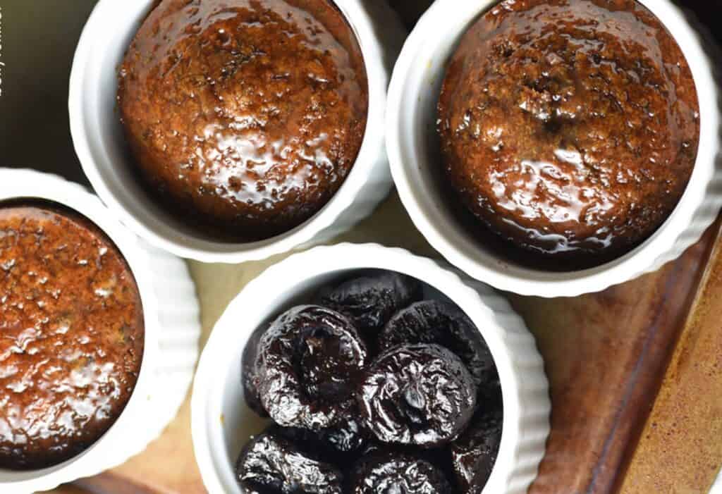 Sticky Toffee Pudding in a baking dish and a bowl of prunes