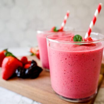 two glasses of pink super smoothie with striped straws
