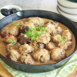 a cast iron pan filled with swedish meatballs