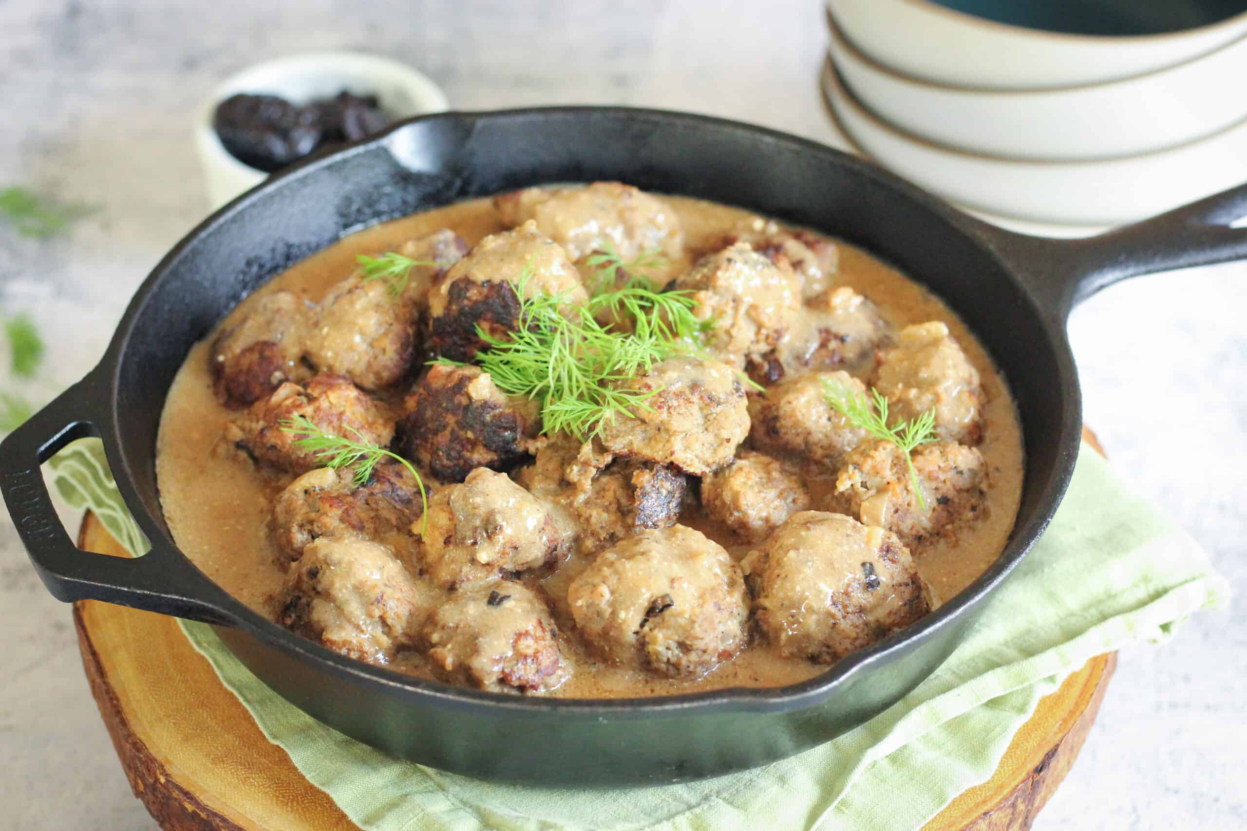 a cast iron pan filled with swedish meatballs