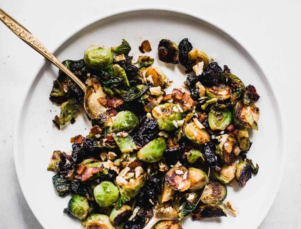 a white plate filled with Sweet and Salty Brussels Sprouts from Heartbeet Kitchen