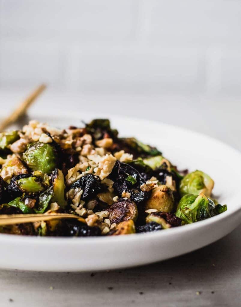 a plate of Brussels Sprouts with bacon and prunes from Heartbeet Kitchen