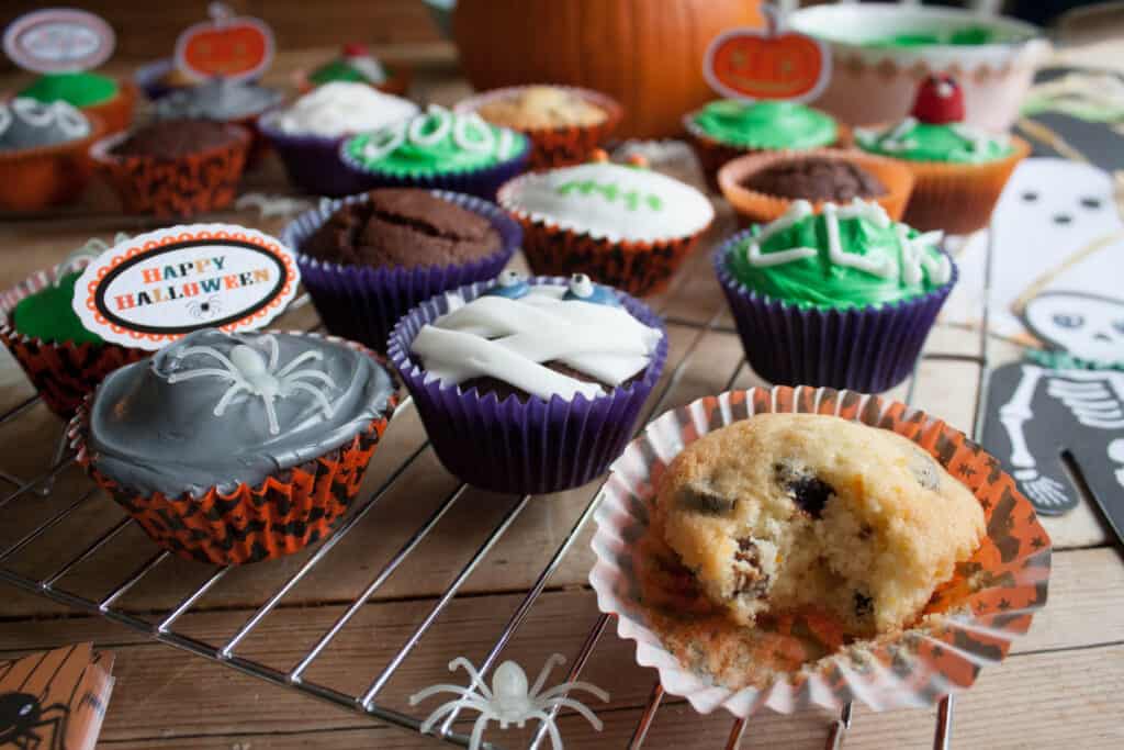 a cooling tray with Orange and Prune cupcakes decorated for Halloween