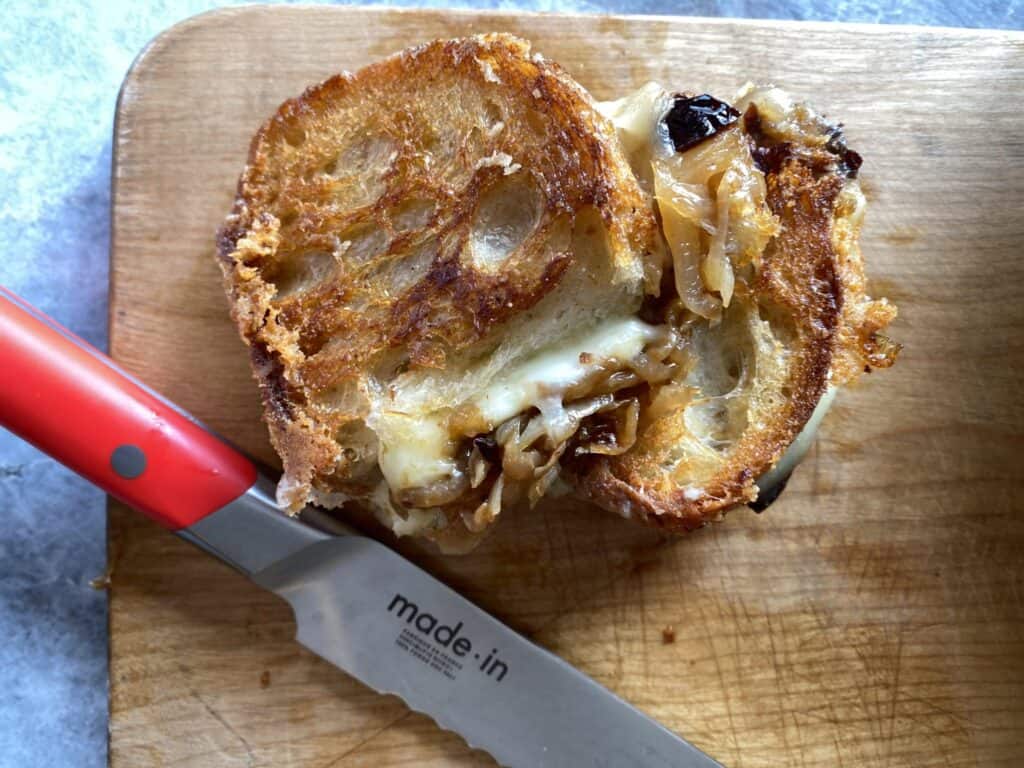 two halves of a grilled cheese with caramelized onions and prunes from No Crumbs Left
