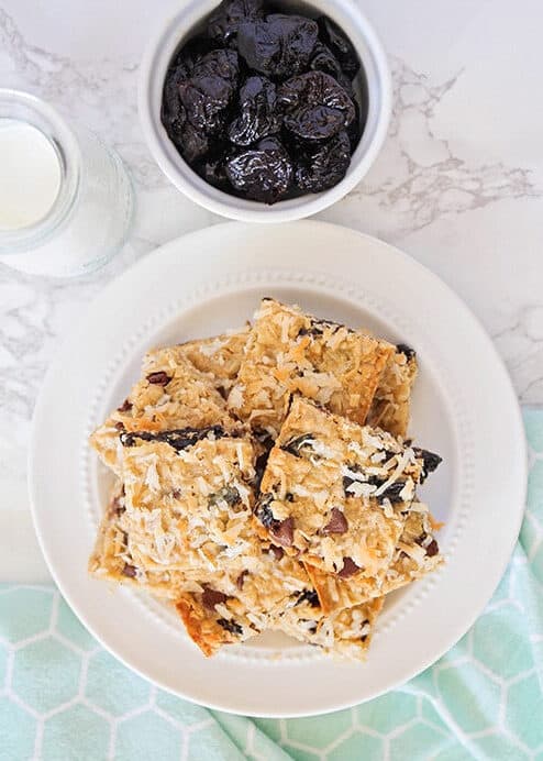 a plate of oatmeal prune bars from somewhat simple and a bowl of prunes