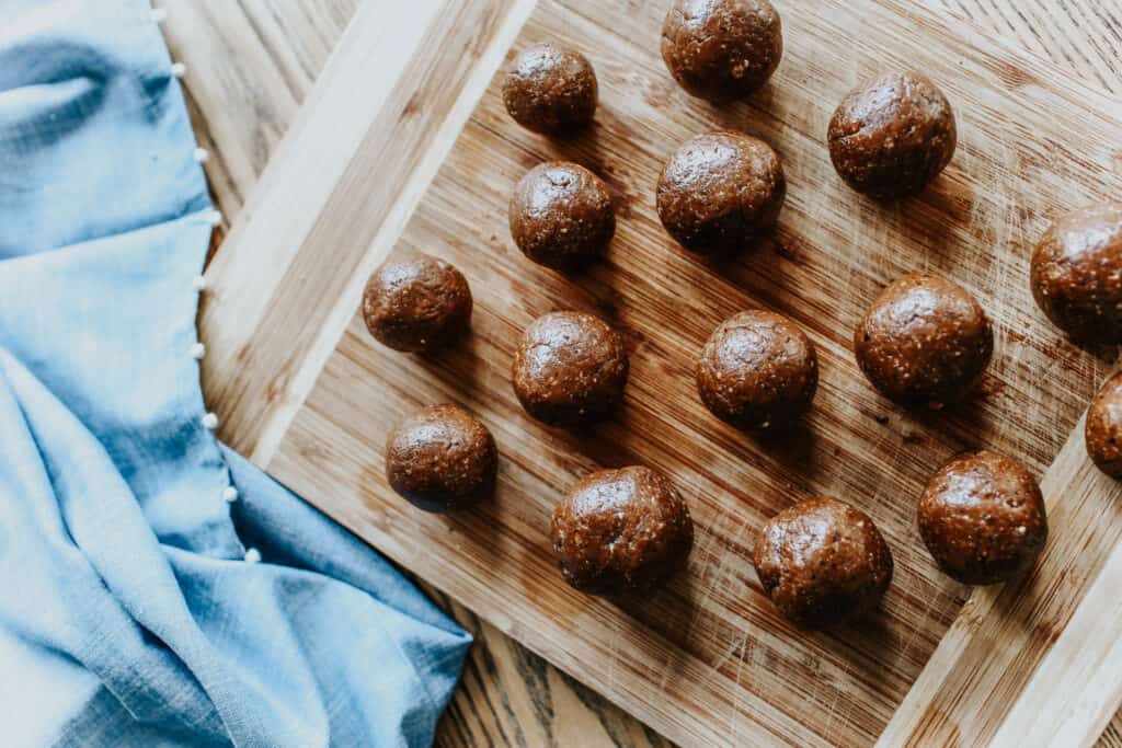 Peanut Butter and Prune Energy Bites from Lows to Luxe on a wooden cutting board