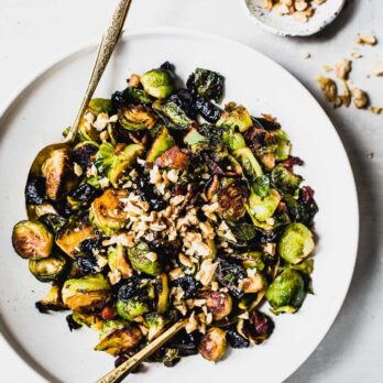 Sweet and Salty Brussels Sprouts from Heartbeet Kitchen on a white plate with a spoon